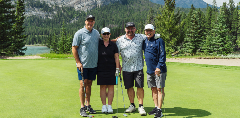 Laurie and three other golfers on a golf course
