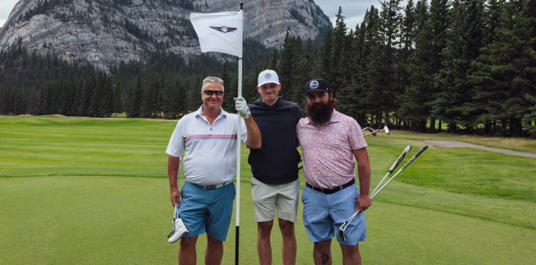 Brian and two other golfers on a golf course