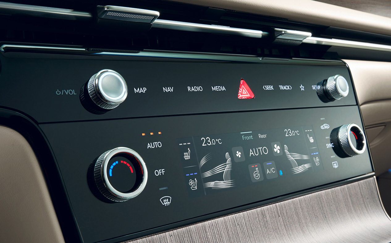 A close-up of the air conditioning control panel inside G80.
