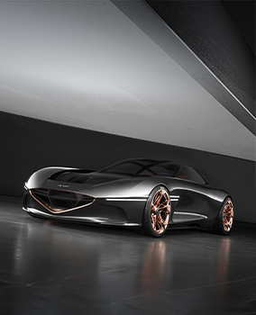The Genesis Essentia concept car is displayed on a smooth floor in a diagonally open space.