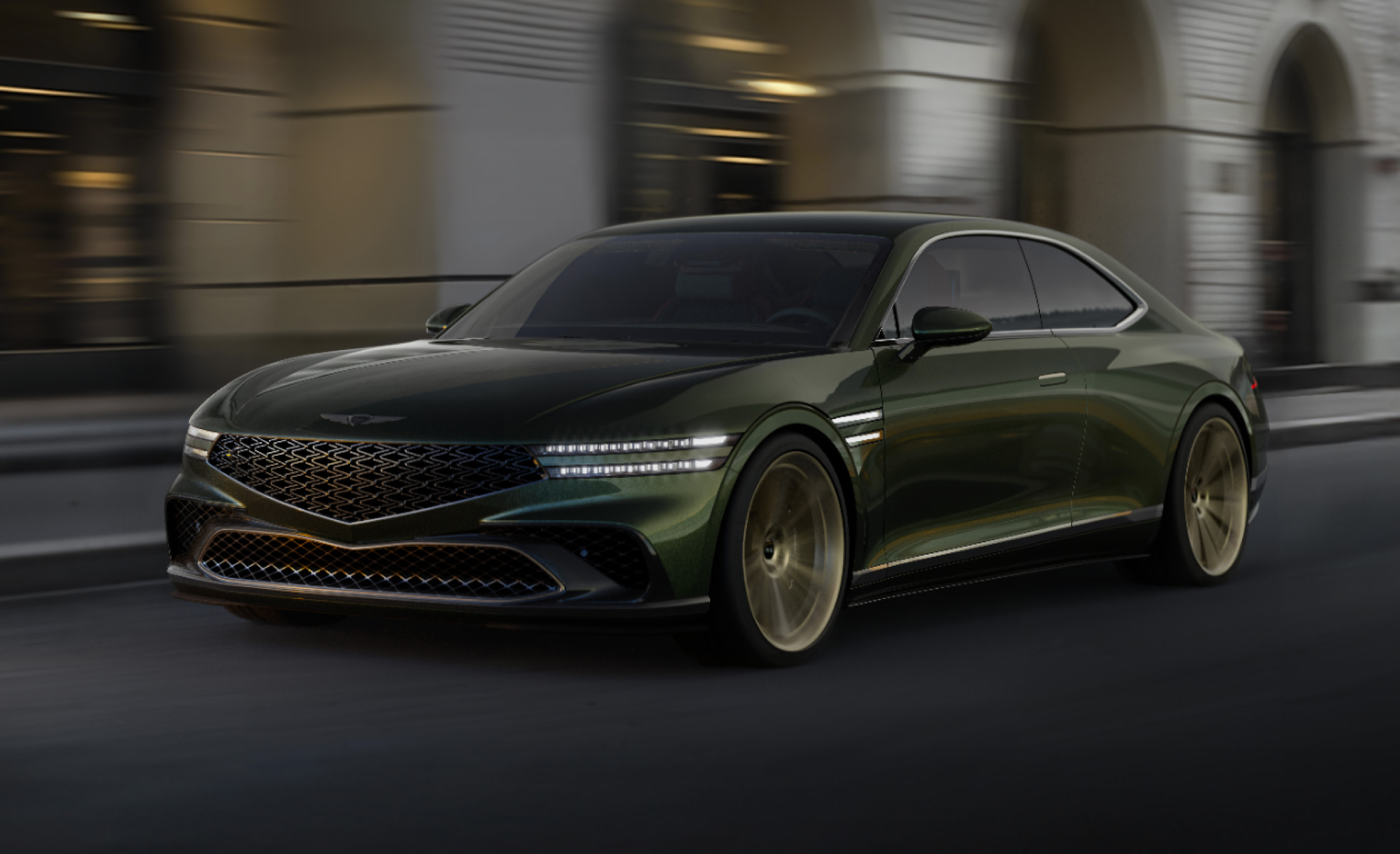 A Genesis X Gran Coupe is driving with a modern city in the background.