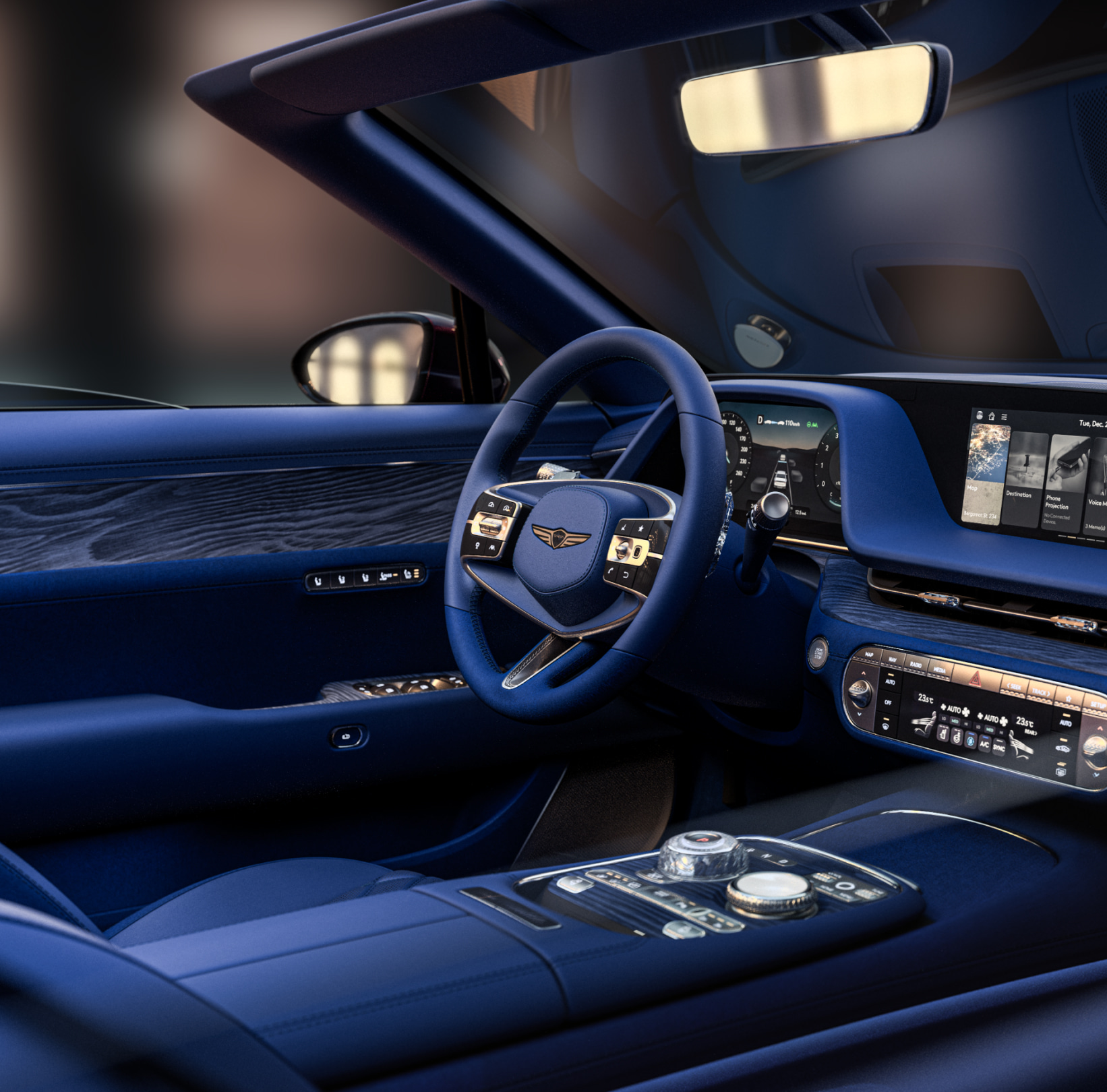 This is the interior driver's seat of the Genesis X Gran Convertible made of eucalyptus wood material. The steering wheel and controllers appear zoomed in.