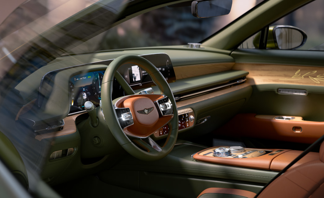 This is a view of the driver's seat from the window with the first row door open. You can see the olive colored car interior.