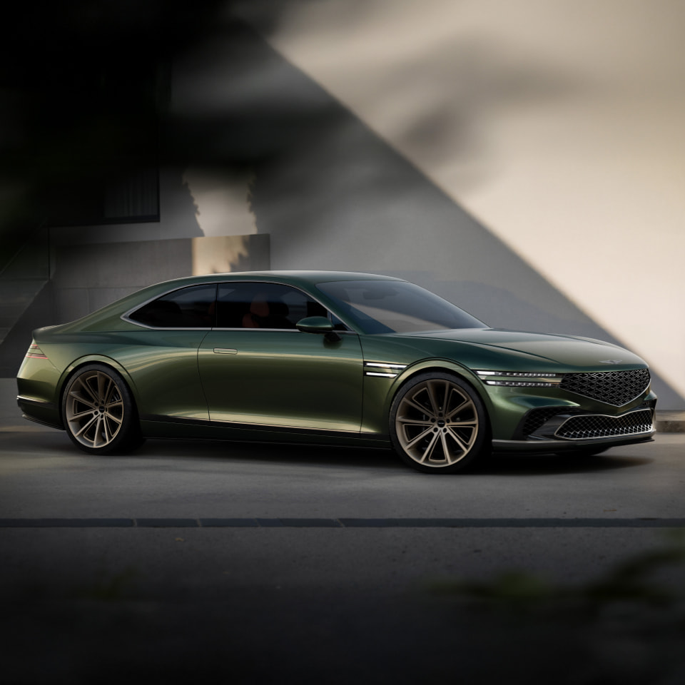 Against a shadowy wall, the Genesis X Gran Coupe Concept is parked on its left side.