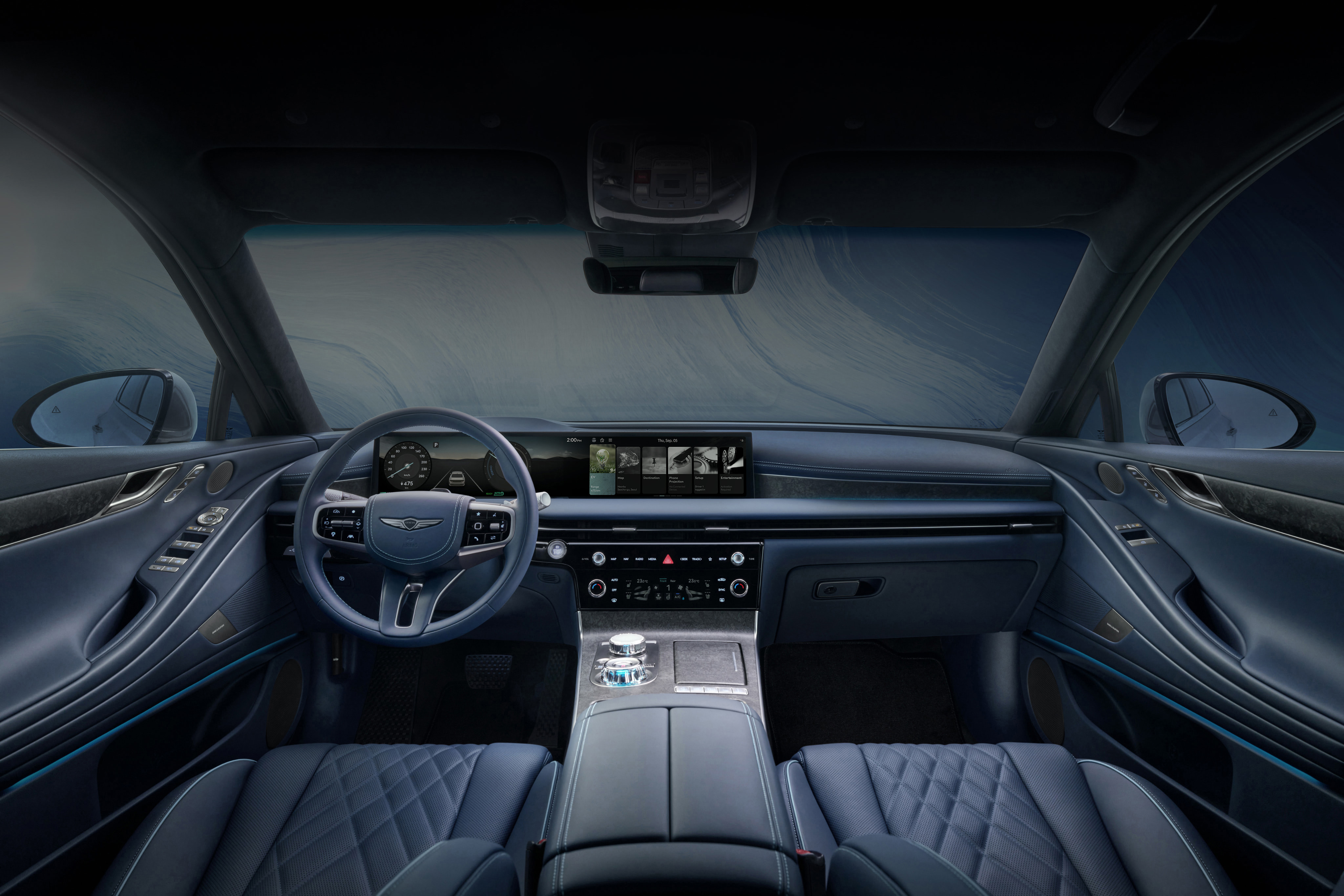 You can see the interior of the front seat of the Eletrified G80 vehicle, with a wide display in the centre of the front of the vehicle and a blue interior light subtly illuminates the interior of the vehicle.