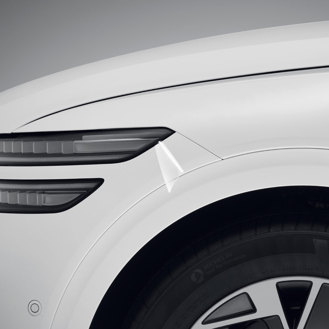 A partial view of the side of the Electrified GV70 in Uyuni White. The film on the surface of the vehicle is highlighted.