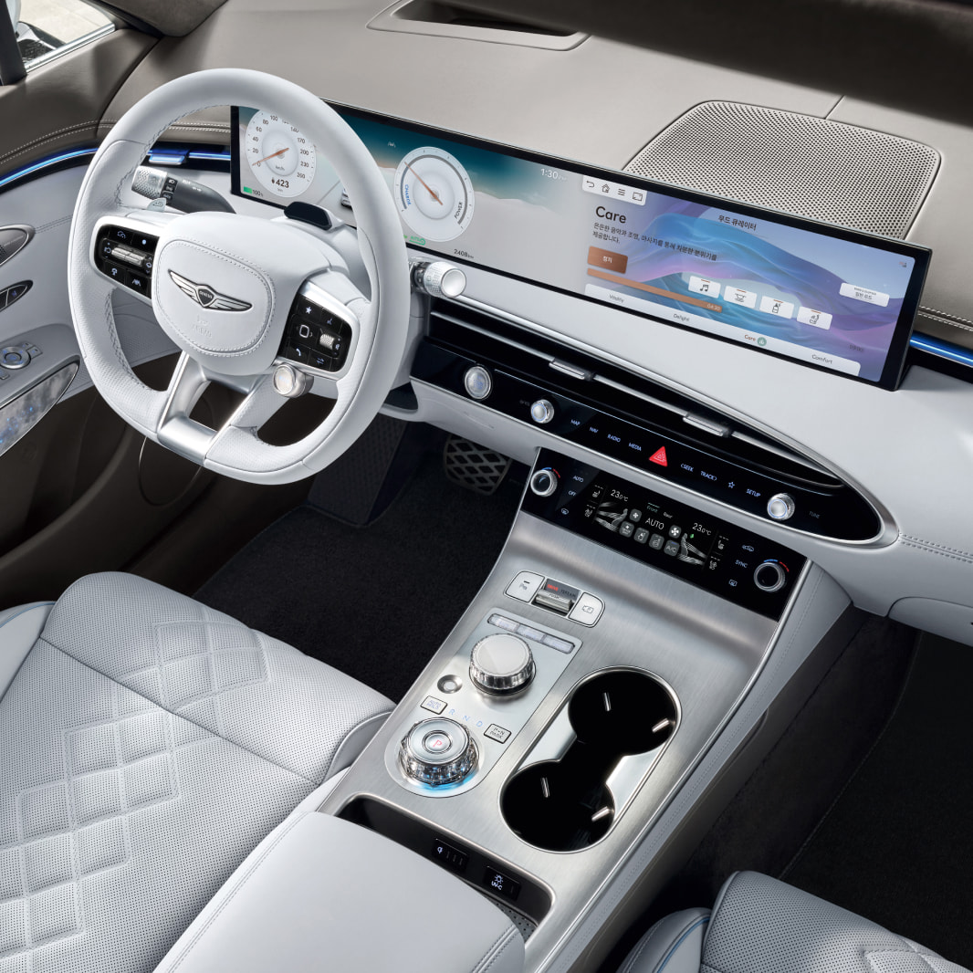 A view looking down at numerous function buttons by the driver's seat.