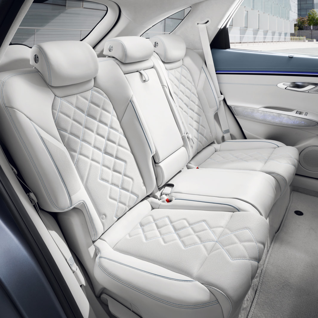A view of the back seat from the open vehicle door. It has been neatly arranged.