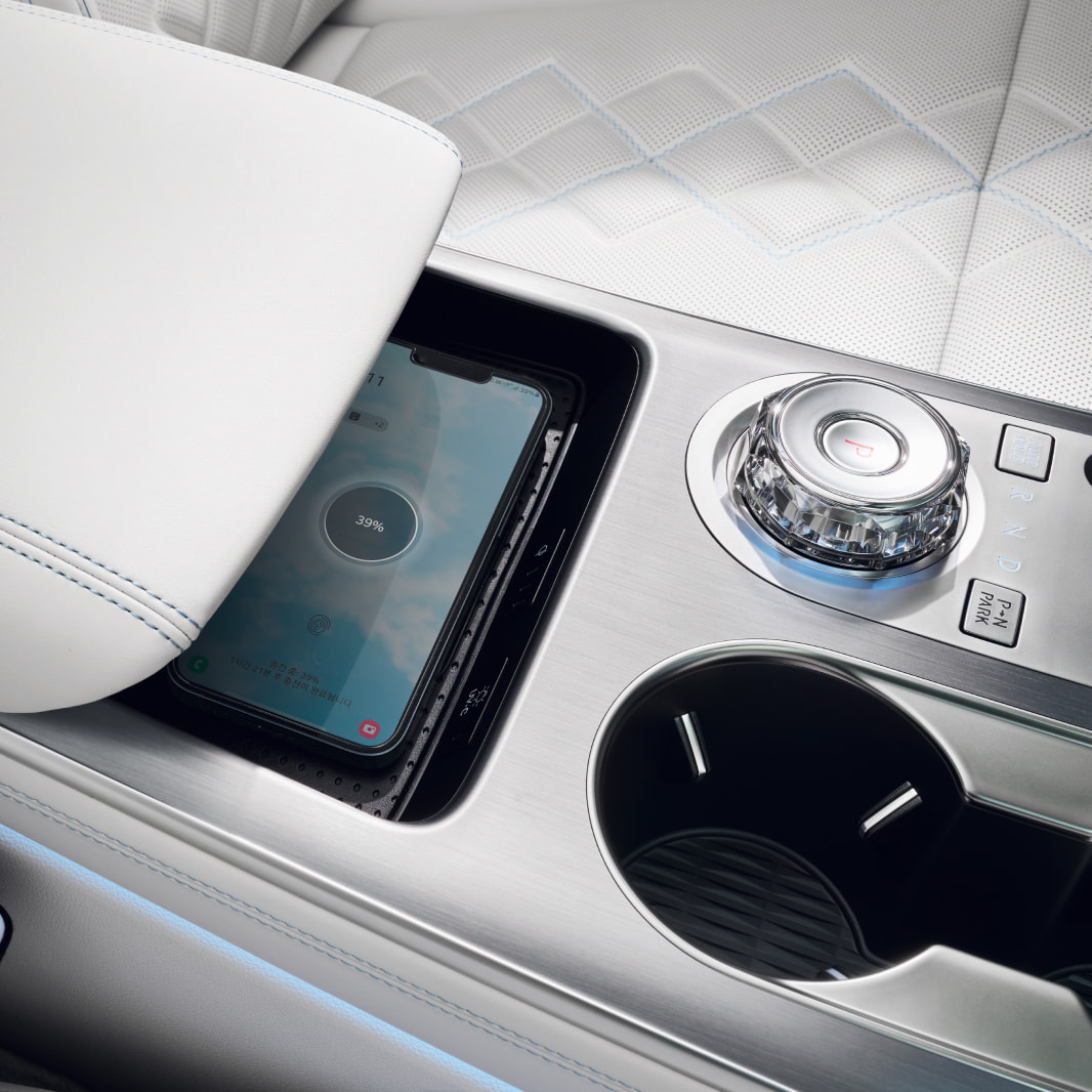 A phone has been placed on the console's charging pad.