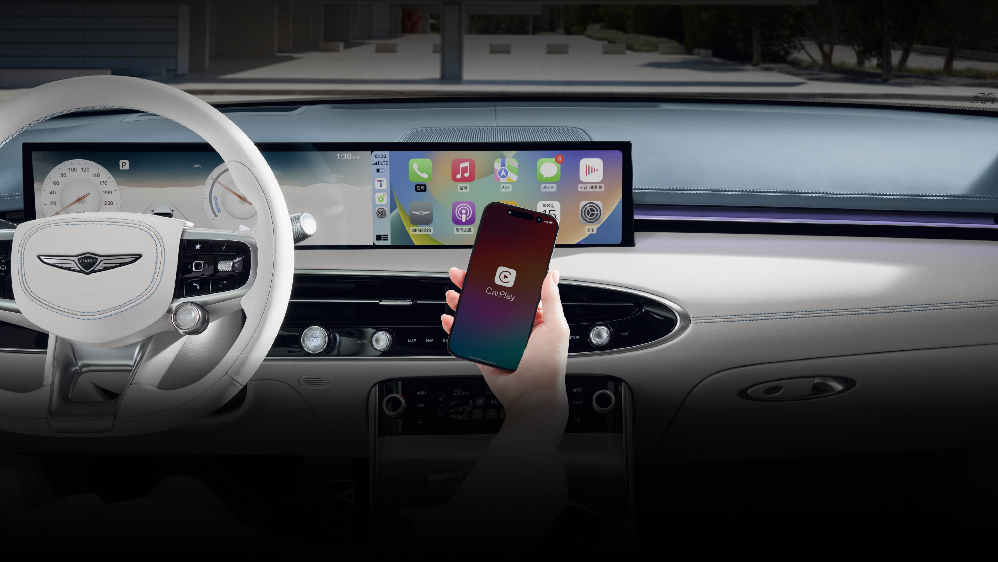 A view of the wide display screen in front of the driver's seat. The driver is holding a phone and trying to connect it to the vehicle.