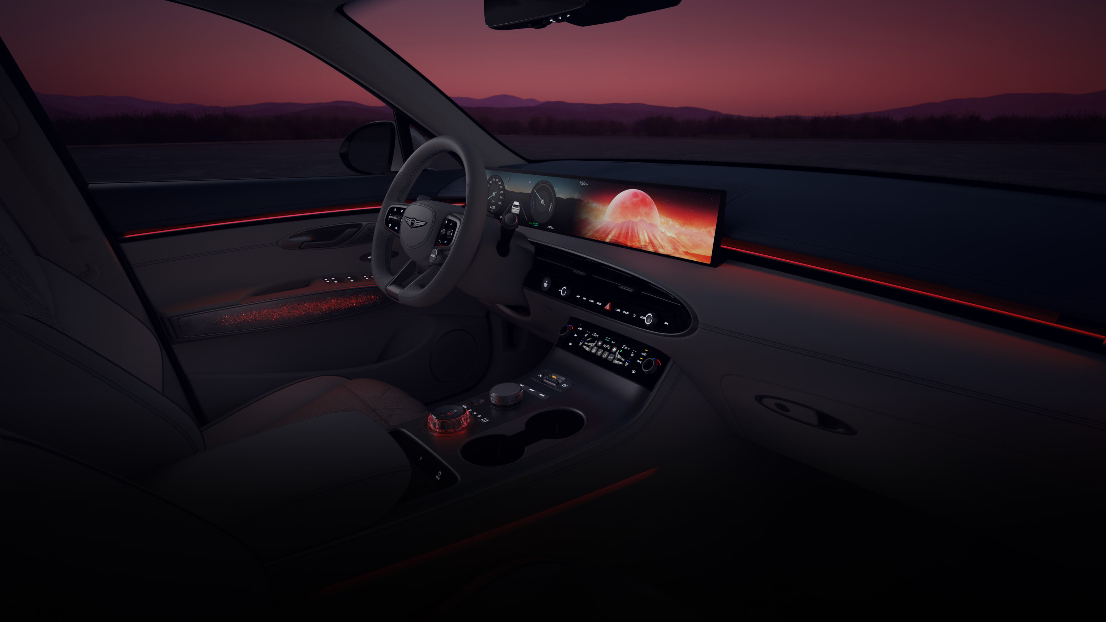 A wide-angle view of the driver's seat from the front passenger's seat. A vibrant array of colorful graphics cycle on the wide display screen in front of the driver’s seat. As the colors on the display shift, so does the ambient lighting of the vehicle's interior. 