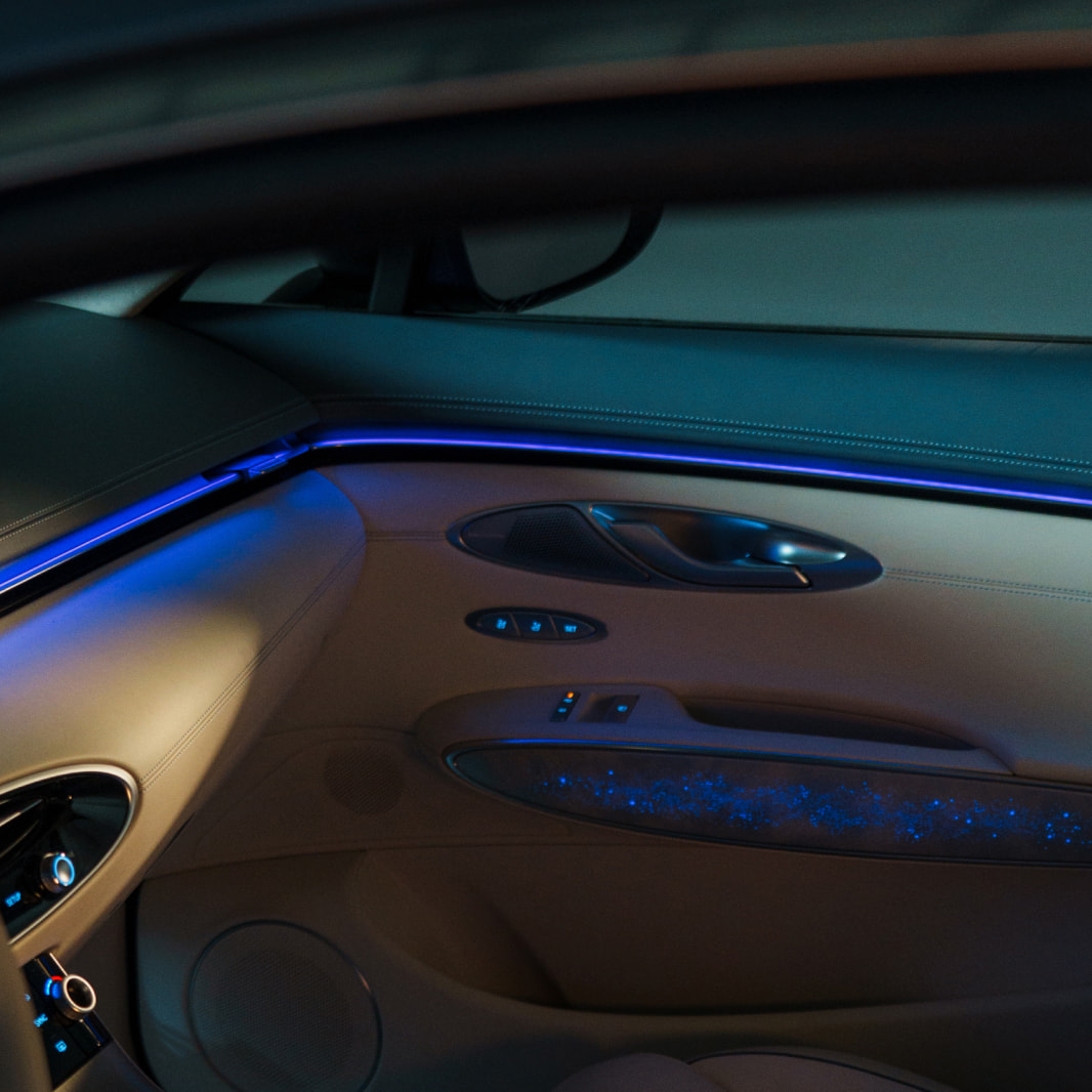 Interior lighting illuminates the area in front of the front passenger seat and by the door.