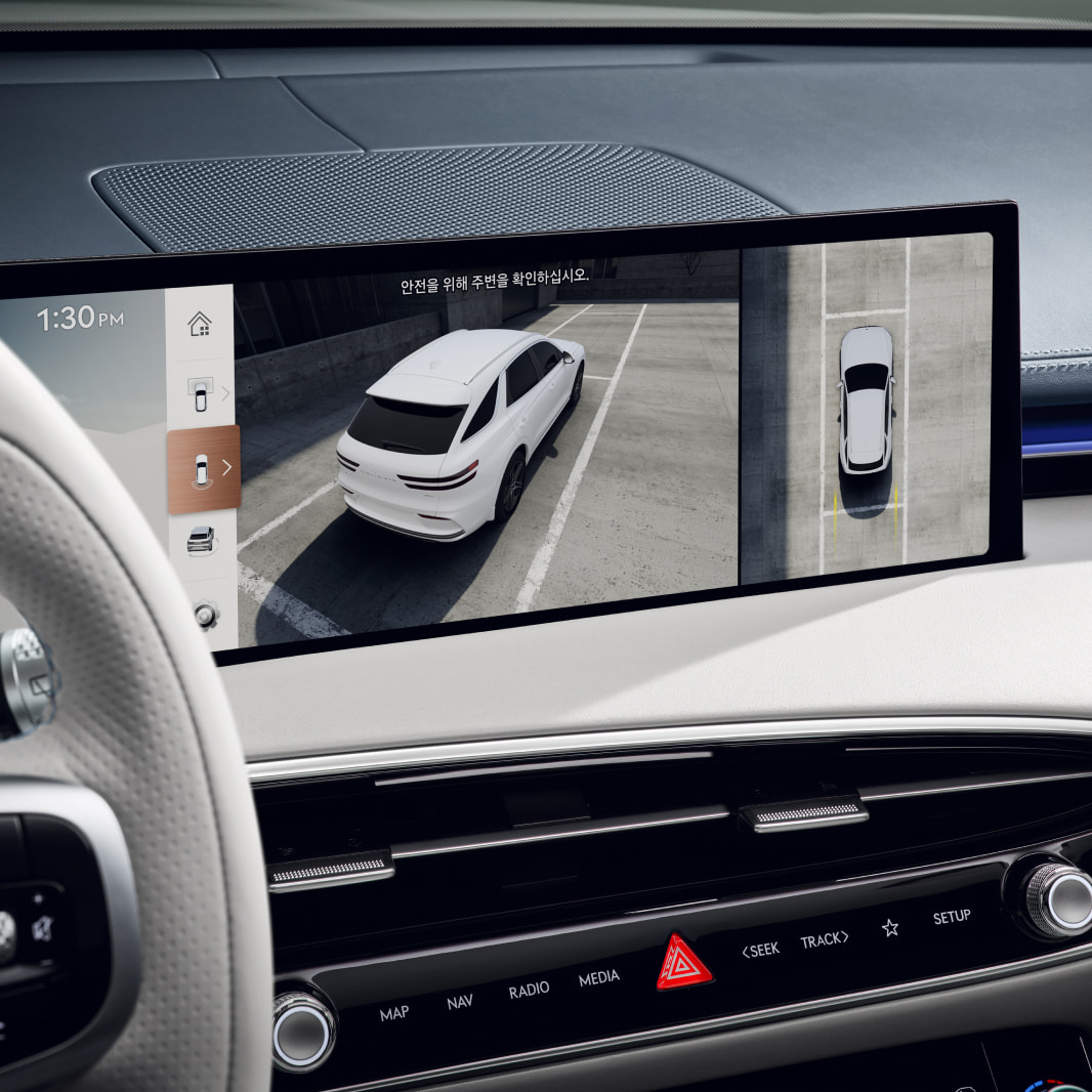 The vehicle's interior display shows a feed of its surroundings, including a top-down view of the vehicle itself.