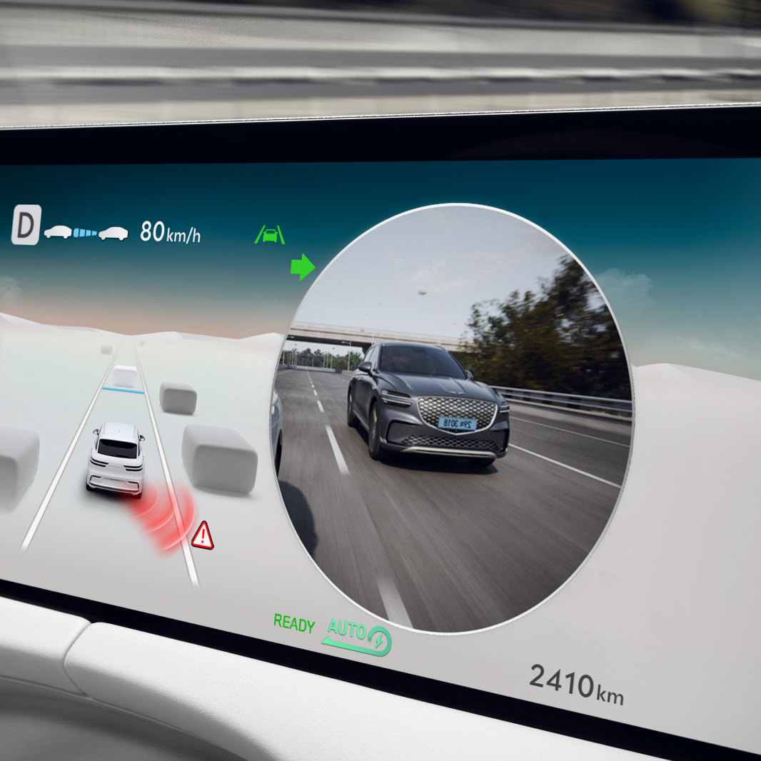 The display screen inside the vehicle shows the view from the rear of the car.