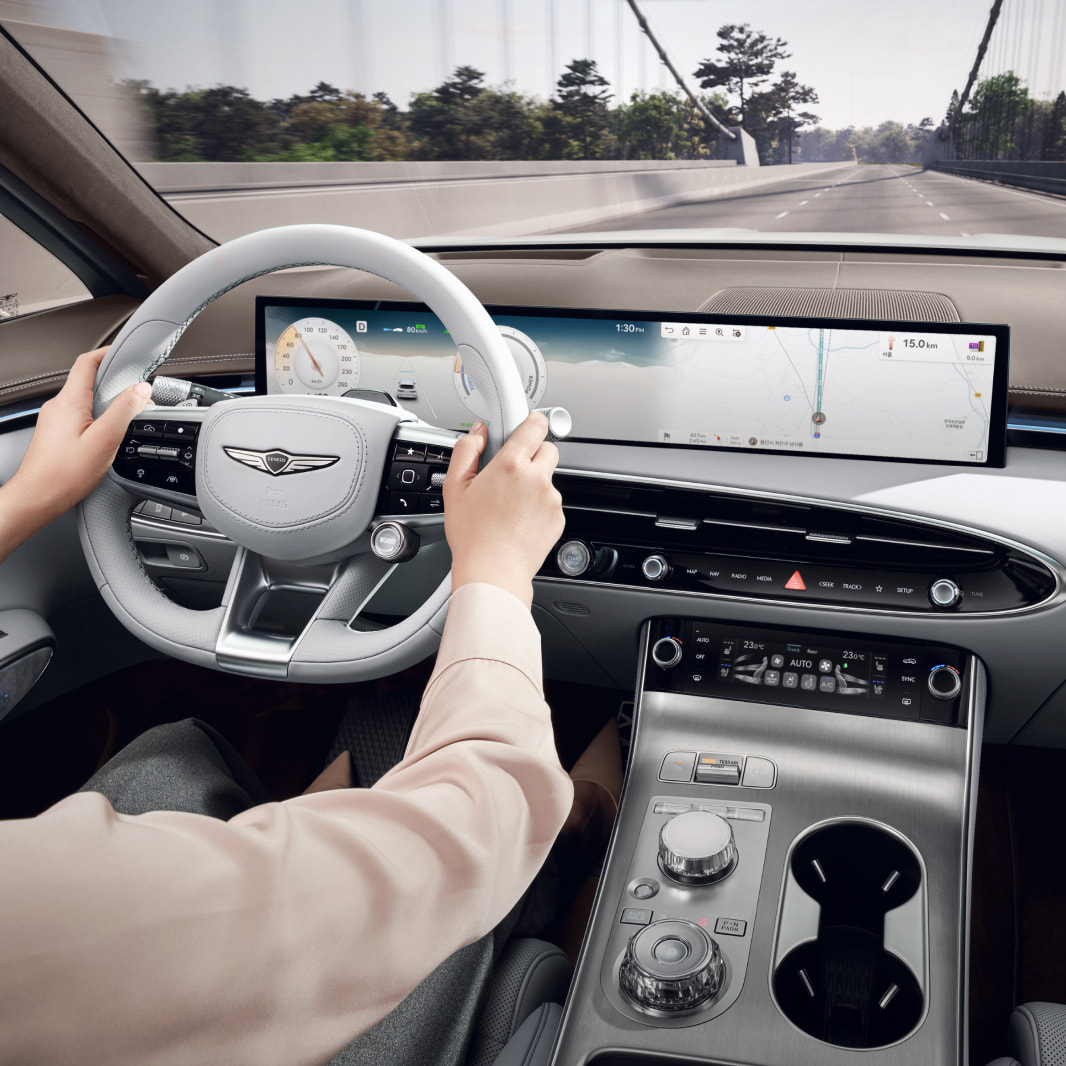 A driver follows the directions of the navigation guidance system. The driver's right hand can be seen gripping the handle.
