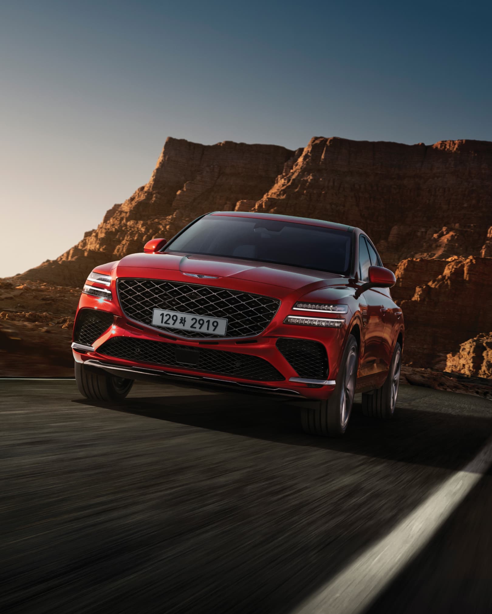 The front end of Mauna Red GV80 Coupe as it drives.