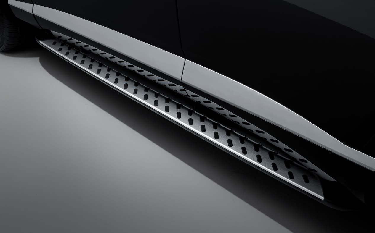 The driver's door of the Vik Black GV80 Coupe is closed and there is a black diagonal pattern on the silver steps.