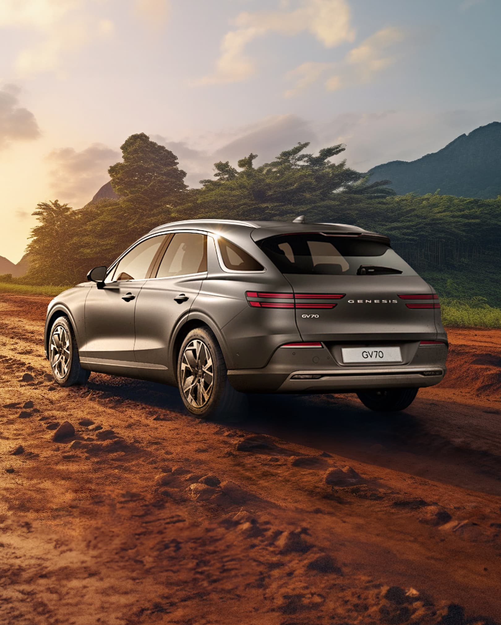 The Electrified GV70 drives on a muddy road.