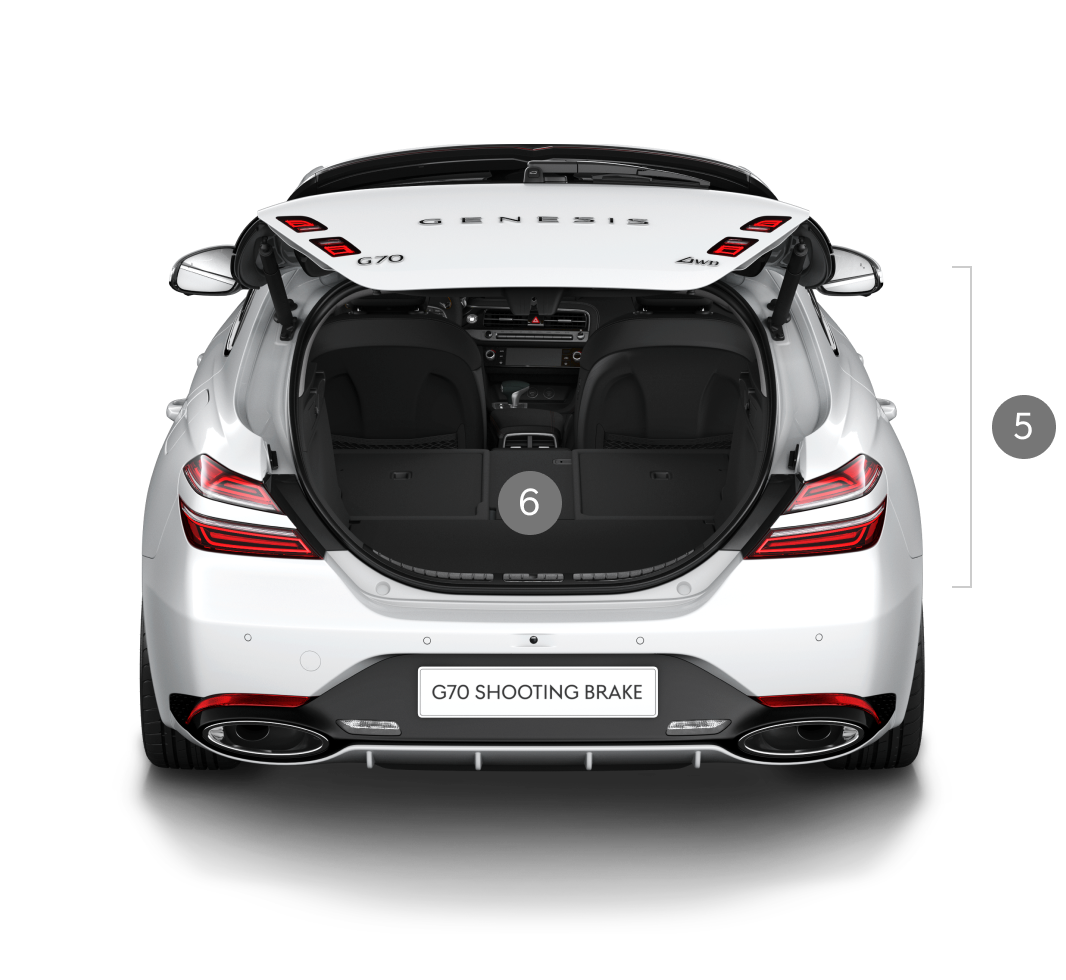 The trunk of G70 shooting brake in Uyuni White is seen through the open trunk door.