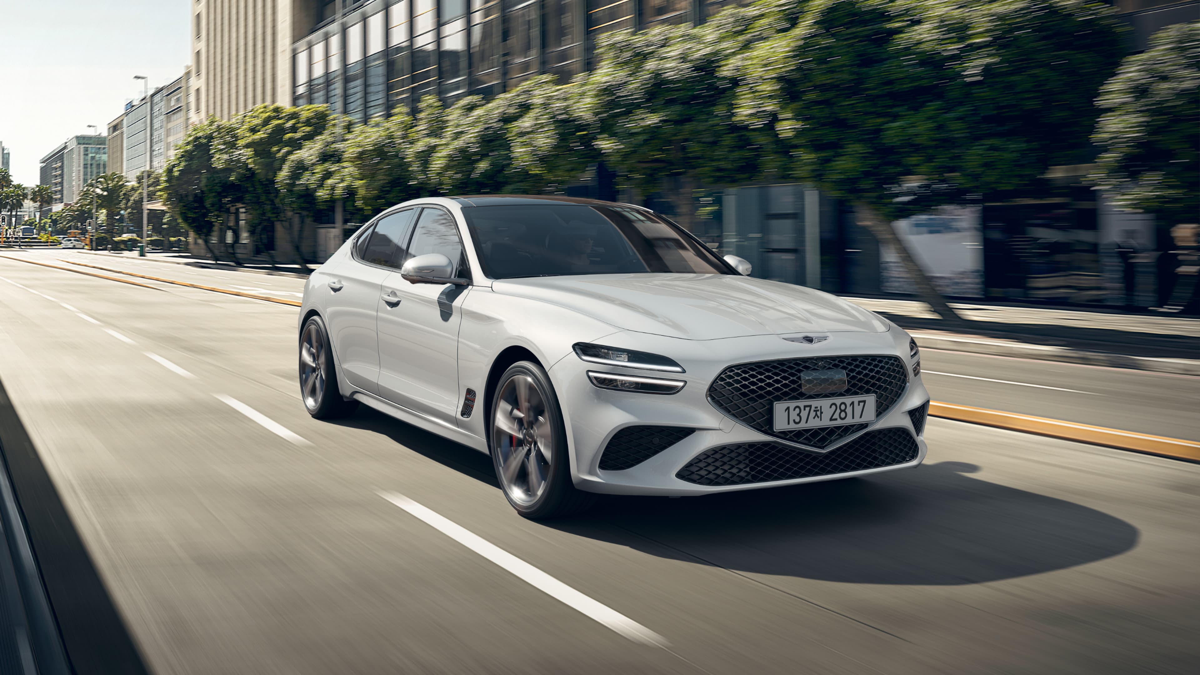 An image of the Uyuni White G70 driving in the city leads to a Cavendish Red G70 passing through a tunnel, and finally, an image of the front of the Makalu Gray G70 Sports model.