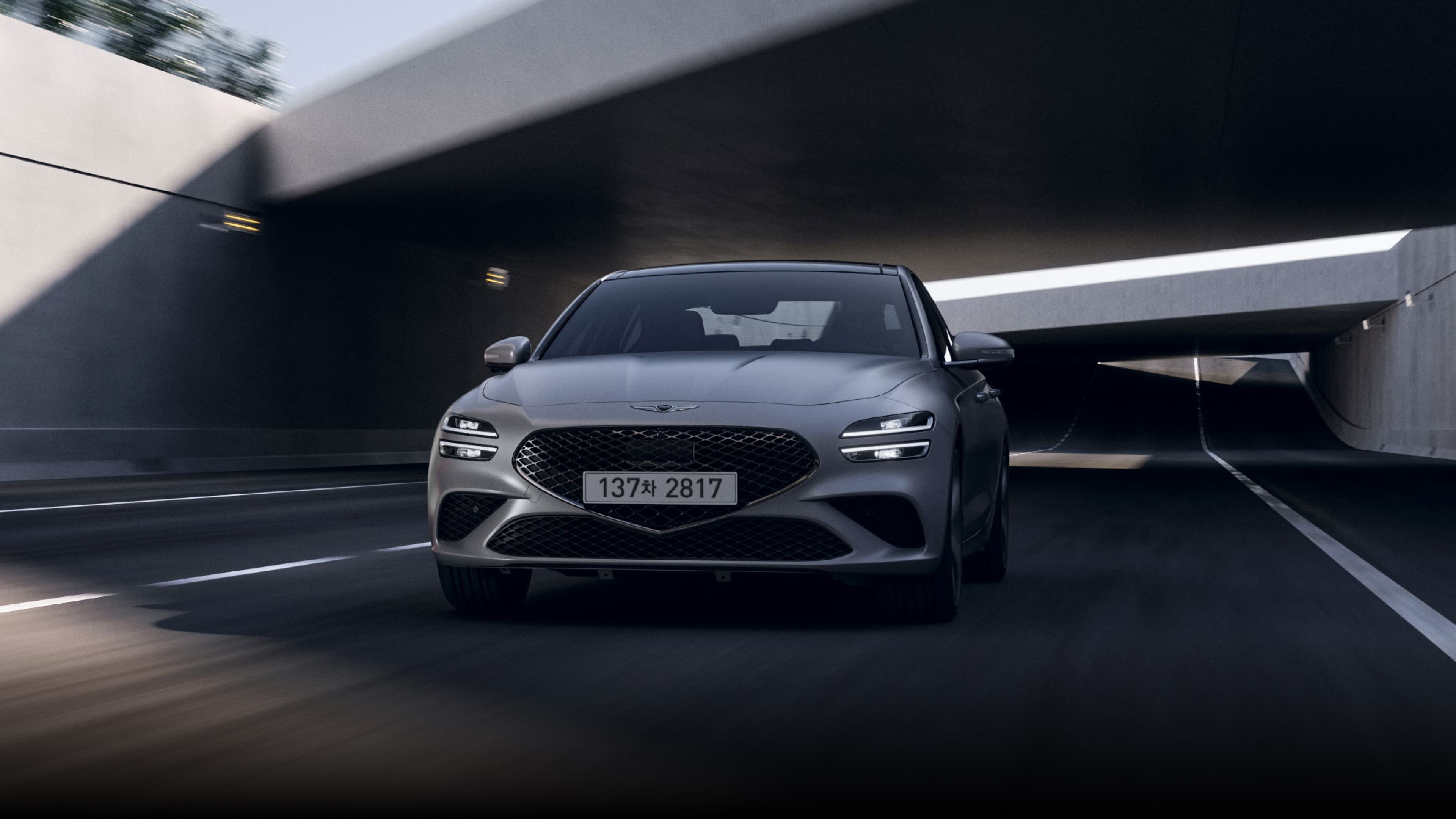An image of the Uyuni White G70 driving in the city leads to a Cavendish Red G70 passing through a tunnel, and finally, an image of the front of the Makalu Gray G70 Sports model.
