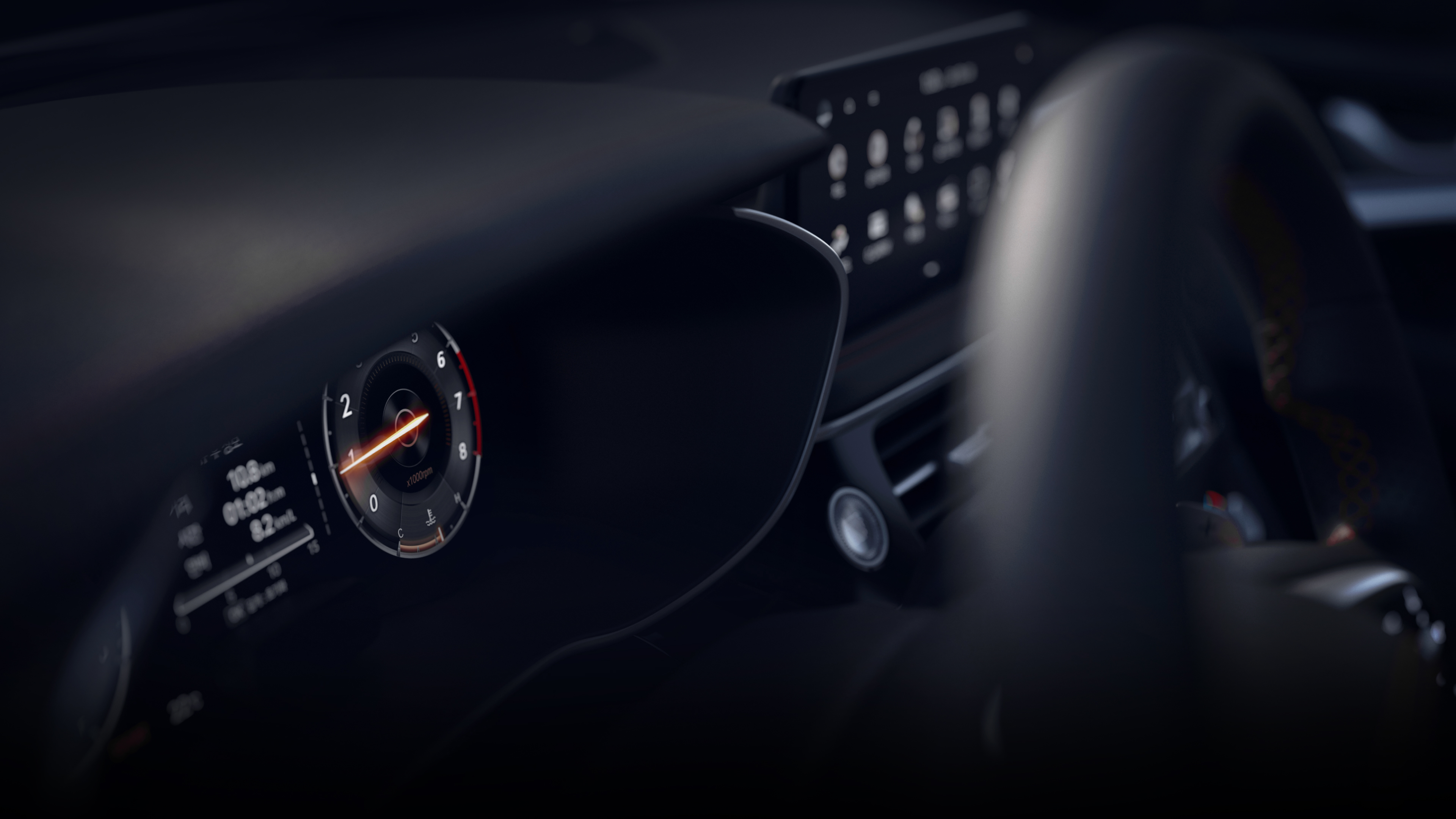 The cluster, steering wheel, and infotainment system seen from the side.