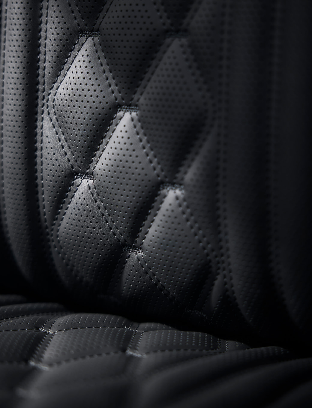 A close-up view of the black leather quilted seat.