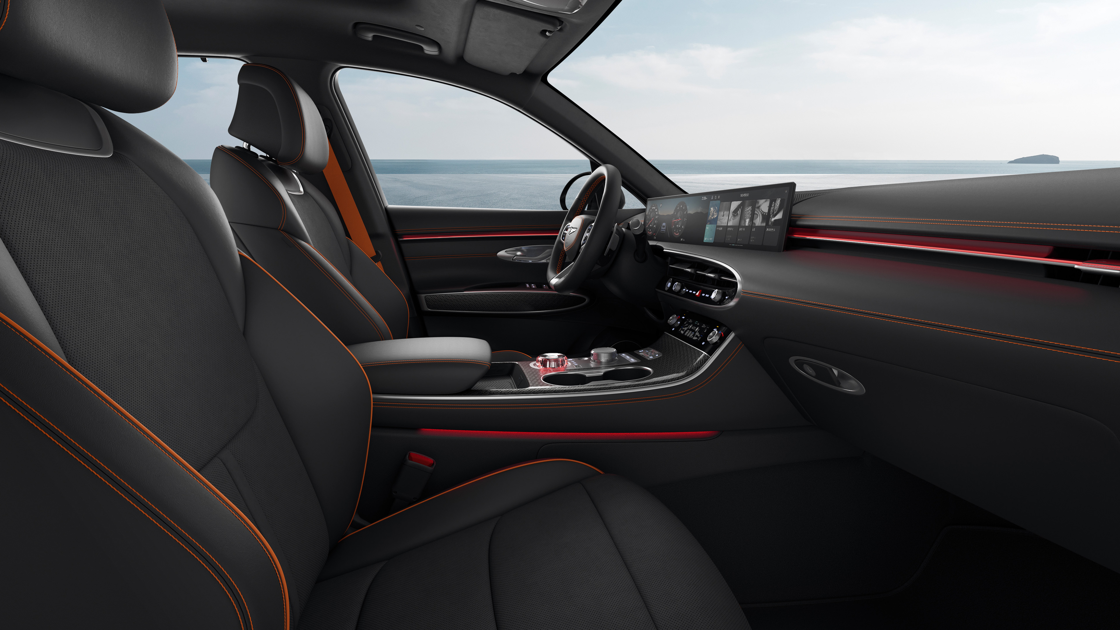 You can see the driver's seat of the GV70 Sports Package with a monotone color of Obsidian Black. The view is from the passenger seat, and there's a subtle red mood lighting.