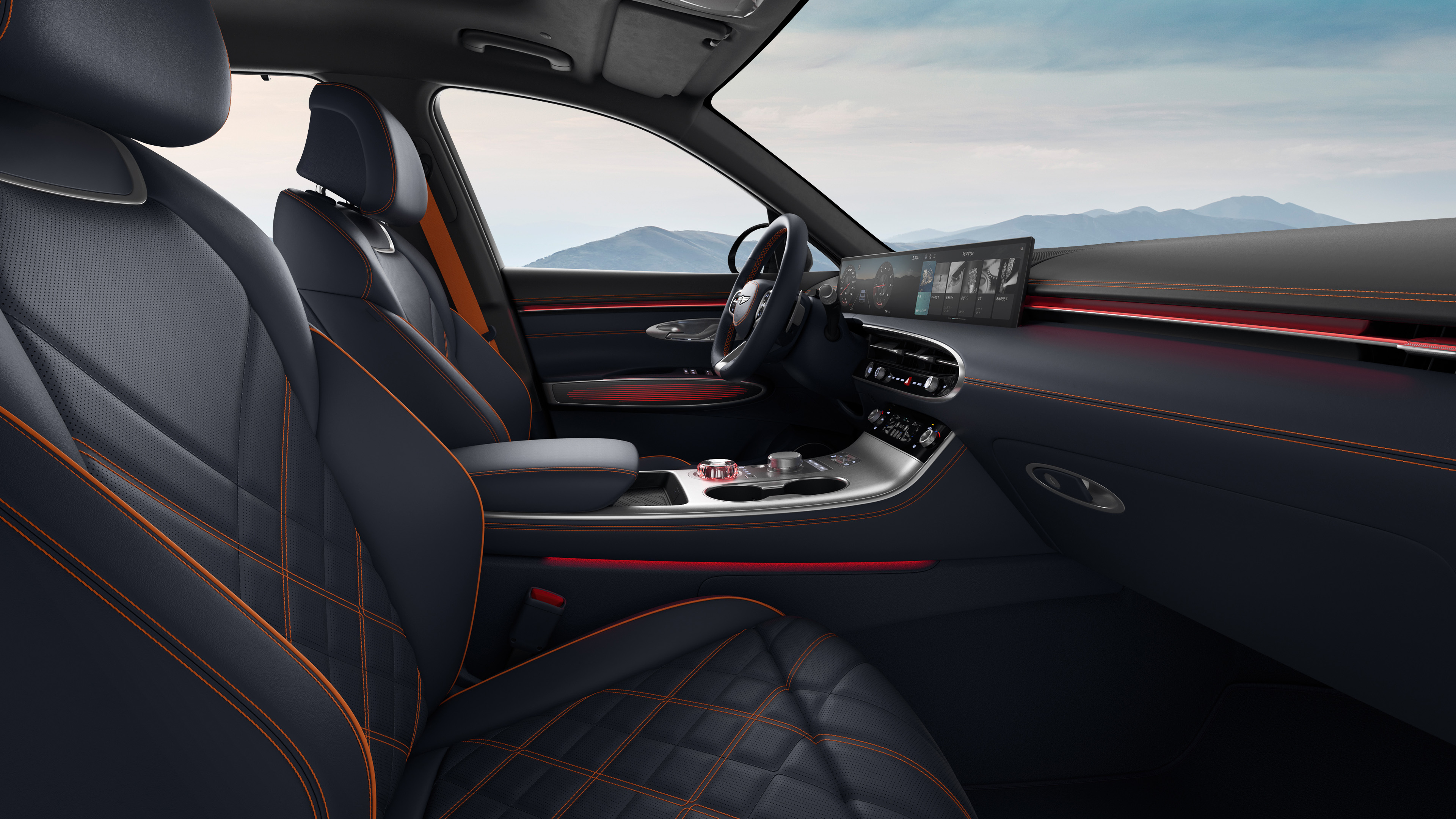 You can see the driver's seat of the GV70 Sports Package with a two-tone color combination of Ultra Marine Blue. The view is from the passenger seat, and there's a subtle red mood lighting.