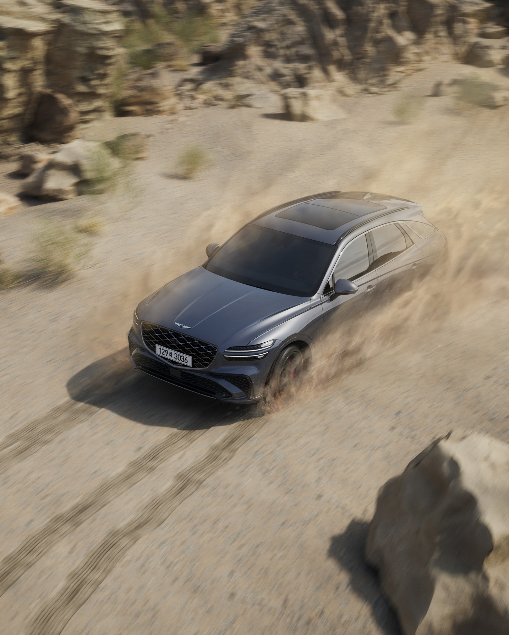 The GV70 is driving dynamically in the desert.