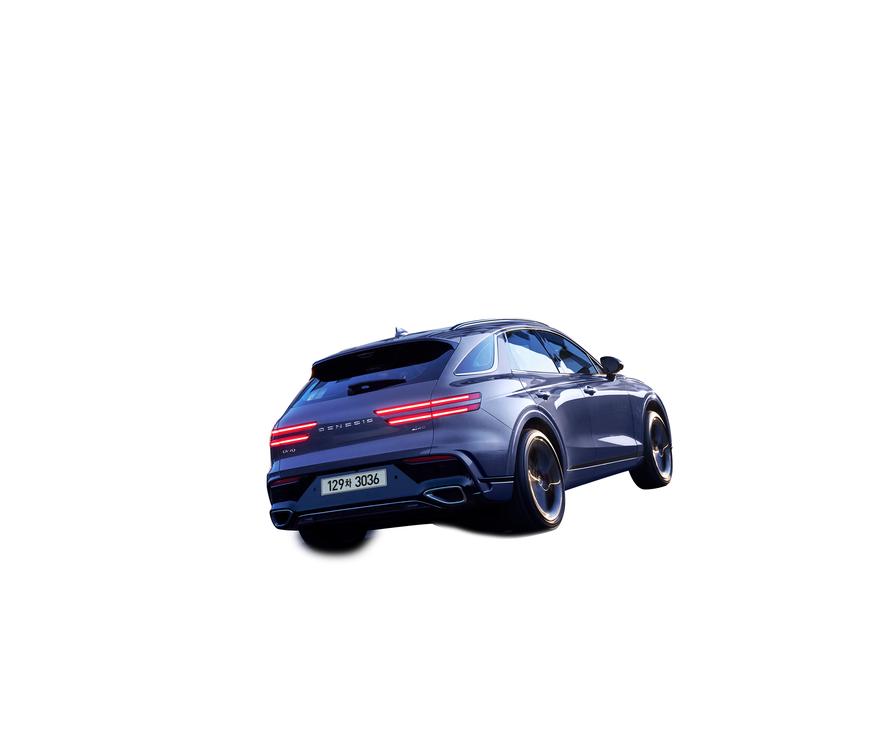 This is a view from the rear of the GV70 driving through a city illuminated by city lights at night.