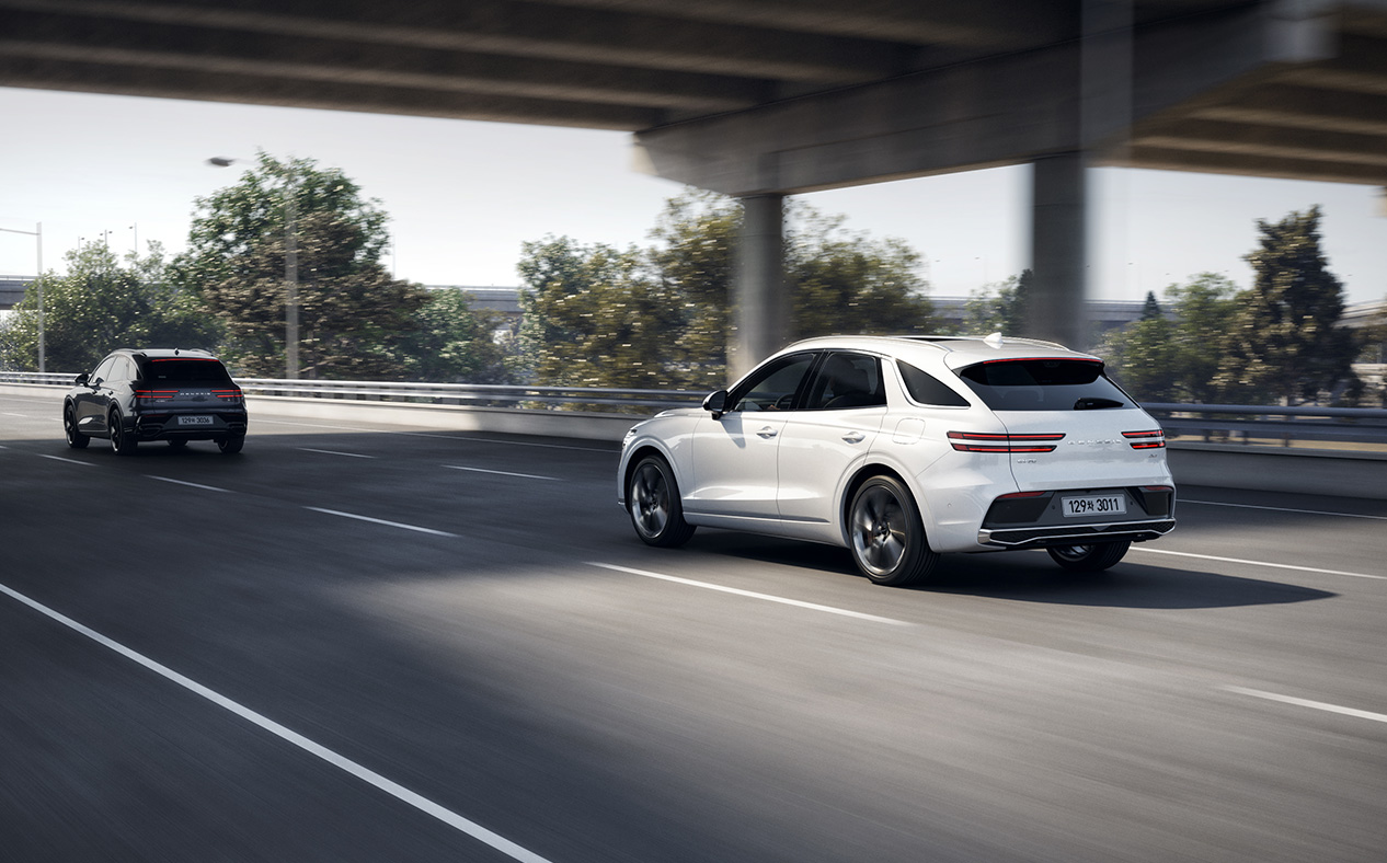 The GV70 is driving on the highway, adhering to its lane.
