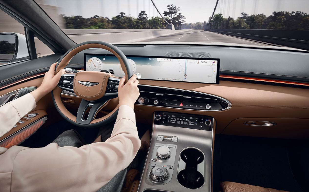 The driver is driving with both hands on the steering wheel.