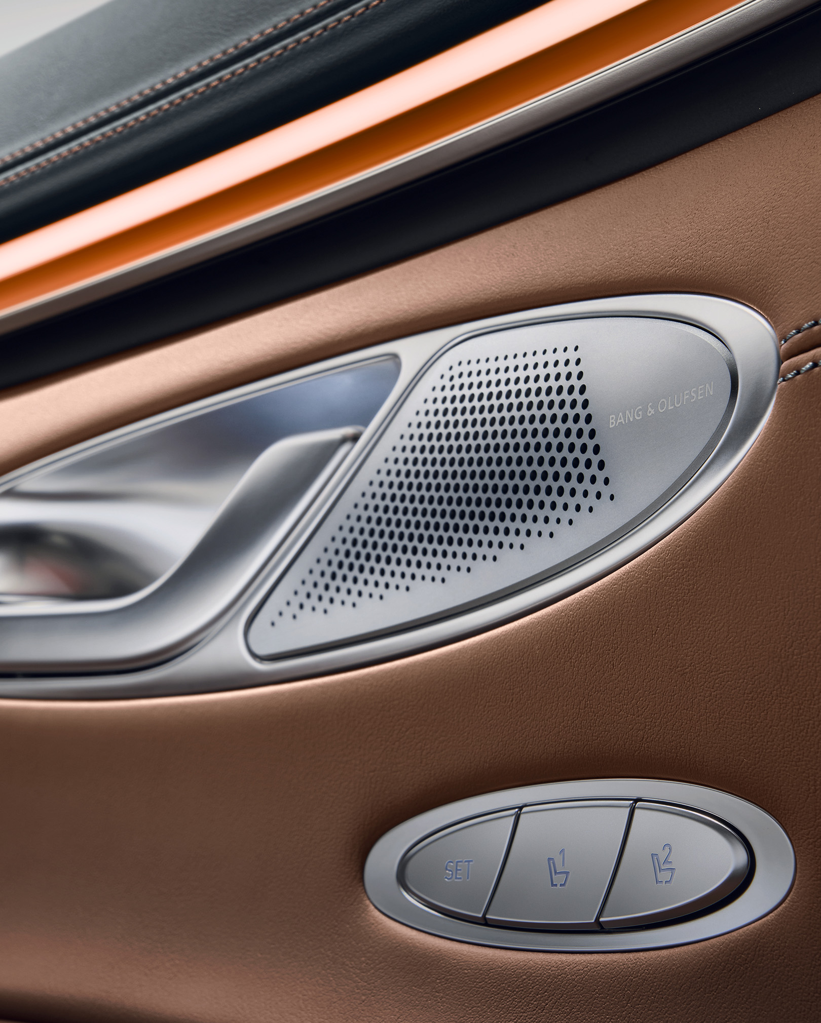 This is an enlarged view of the vehicle's interior speaker. The Bang & Olufsen lettering is written on the aluminum cover.