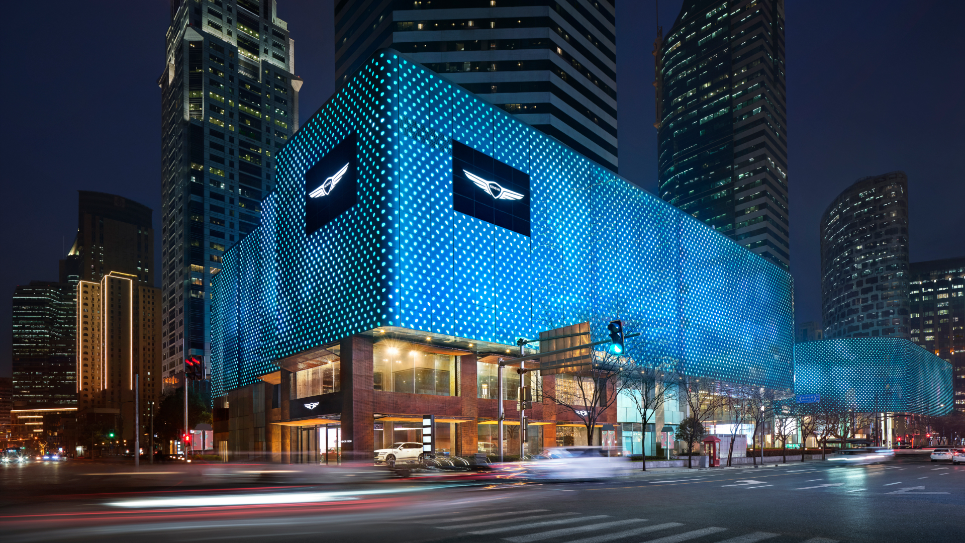   An exterior view of the Genesis Studio Shanghai building in China with orange outdoor lighting.