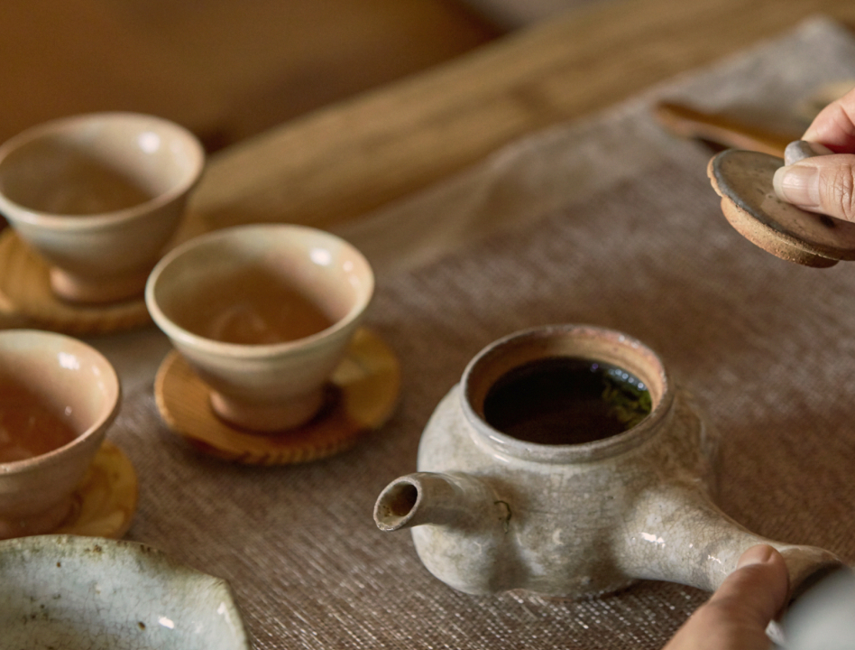 An aged hand performing a tea ceremony.