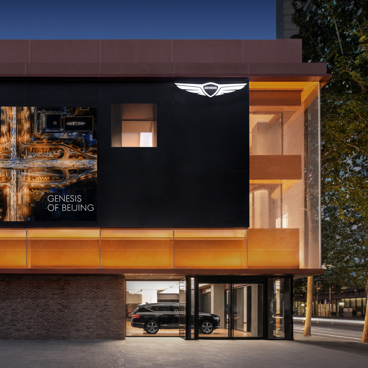 An exterior view of the Genesis Studio Shanghai building in China with orange outdoor lighting.