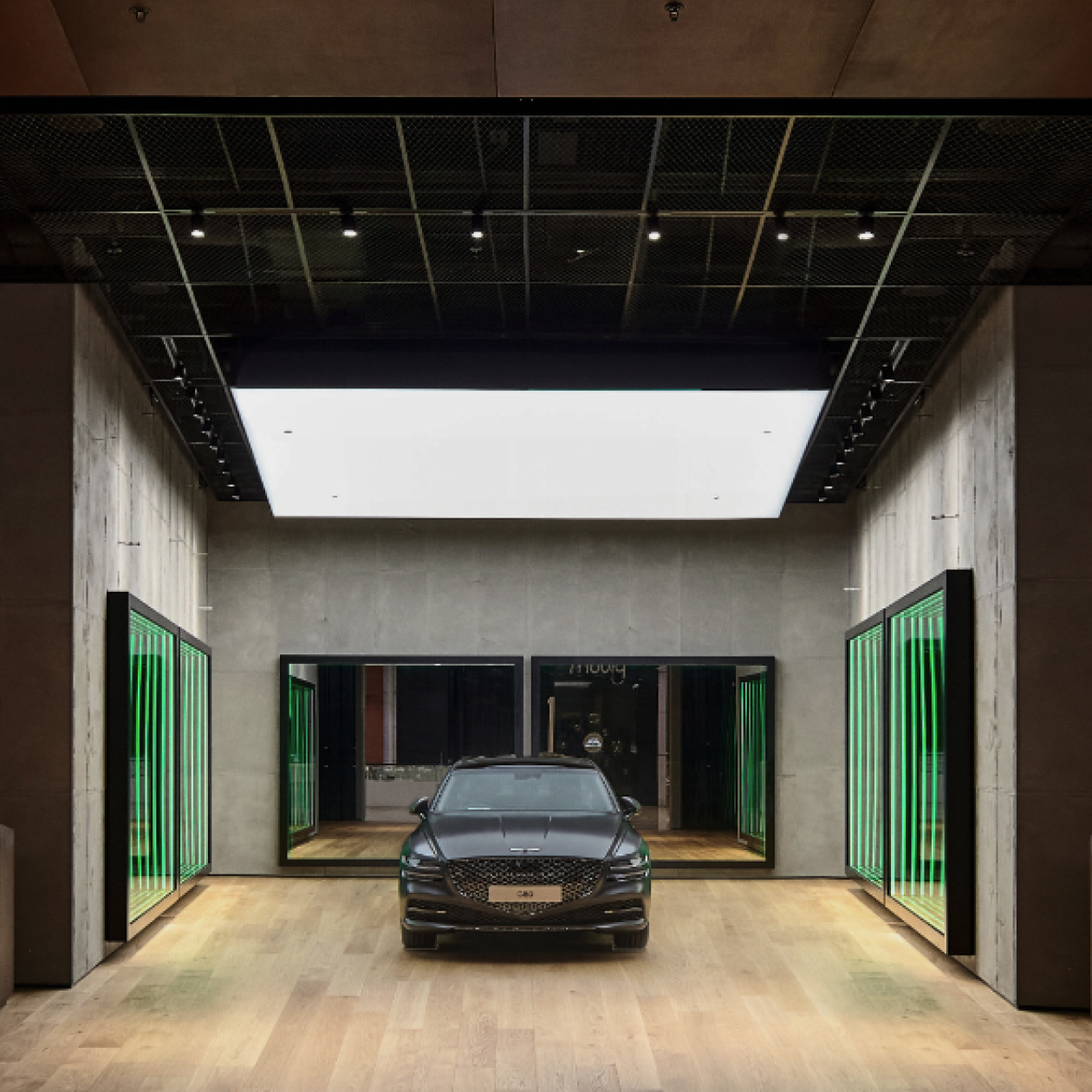 A Genesis vehicle sits in front of the Infinity Mirror inside Genesis Studio Edinburgh in the United Kingdom.